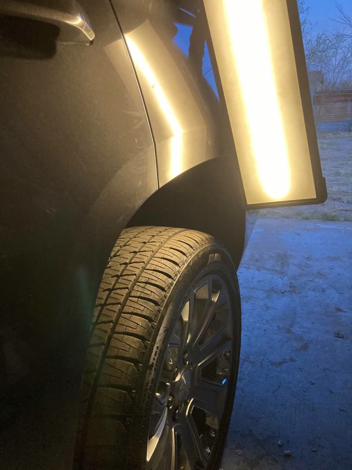 After: the same quarter panel smooth after paintless dent repair