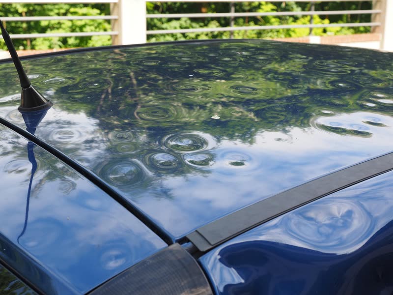 Car roof covered in hail dents